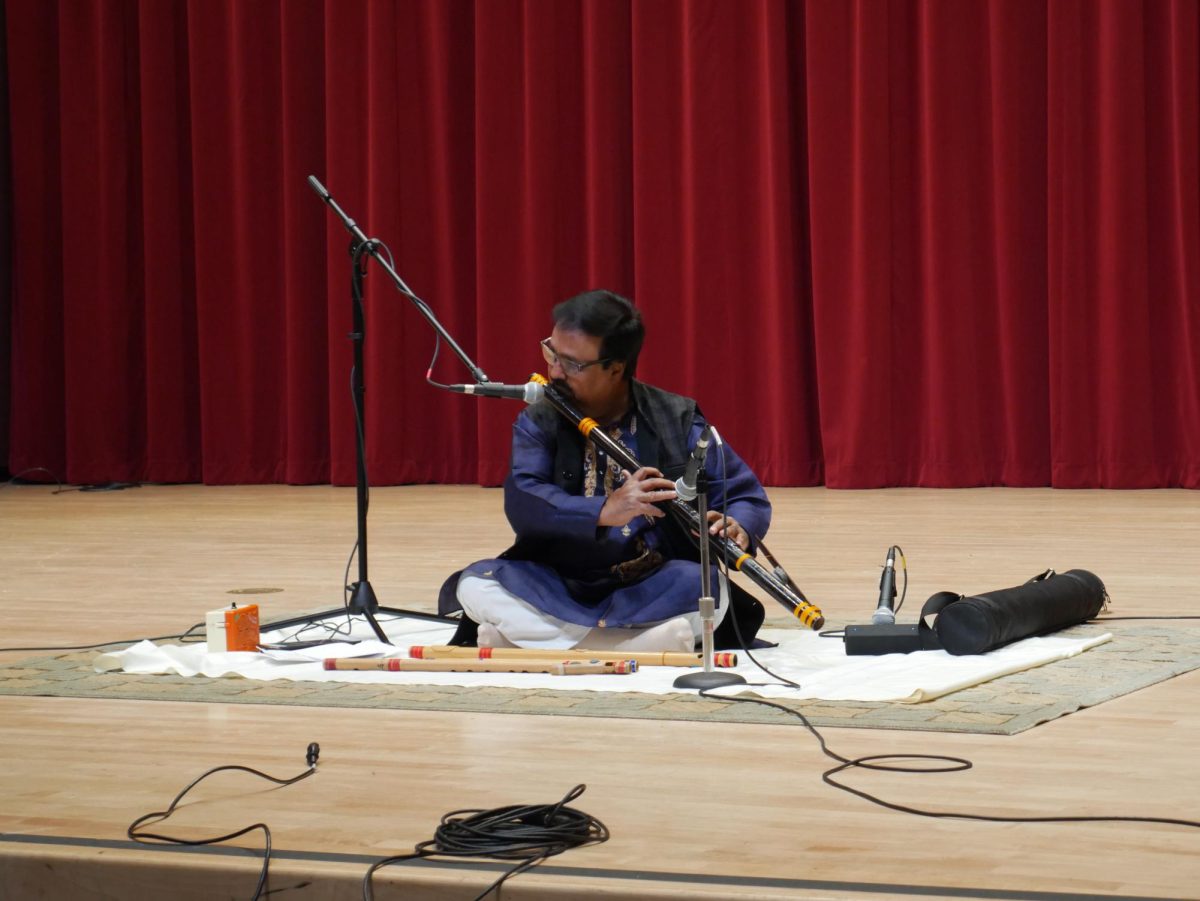 Classical Indian flutist Sunil Kant Gupta plays his flute on stage at Knuth Hall on Tuesday, April 15, 2025. (Olivia Moran / Golden Gate Xpress)